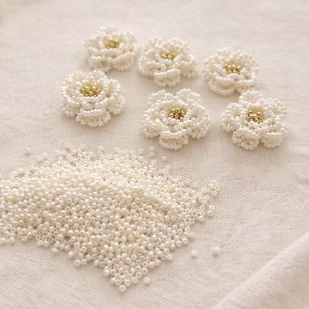 handmade White pearl flowers on a textured white surface