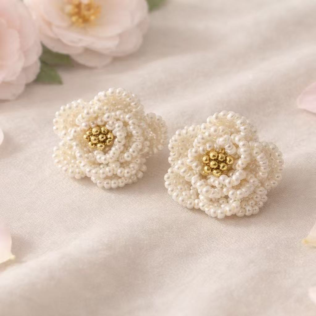 Handmade Pearl flower ring with gold centers on a soft pink background