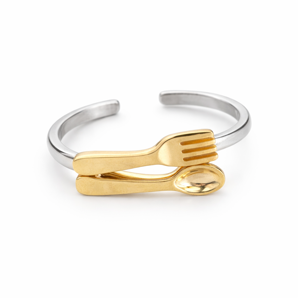 Quirky handmade fork and spoon ring with gold plated cutlery design, a niche art jewelry piece with playful and unconventional style