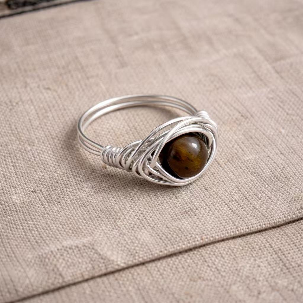 Close-up of a handmade wire metal ring featuring an organic stone, designed for modern urban women.