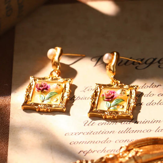 Vintage gold earrings with hand-painted rose artwork in ornate frame design, ideal Christmas jewelry gift.