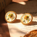 French hydrangea gold stud earrings with pastel enamel floral details.