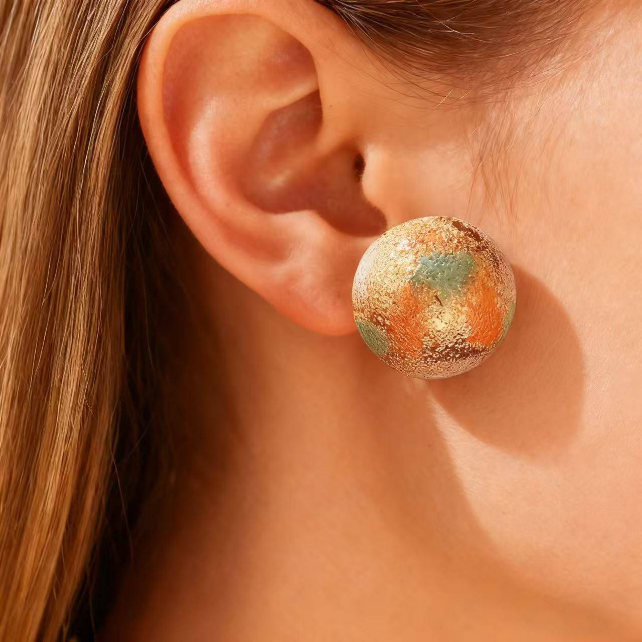 Elegant gold earrings with miniature framed rose painting, perfect for festive jewelry collections.