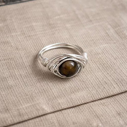 Handcrafted metal ring with wrapped wire design and natural stone centerpiece from the Arbor Aegis Bind collection.
