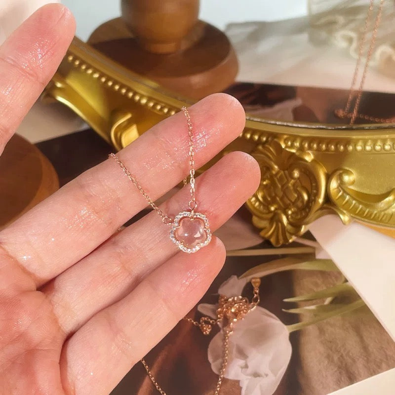 delicate rose gold circle pendant necklace shown on model's hand, elegant minimalist style