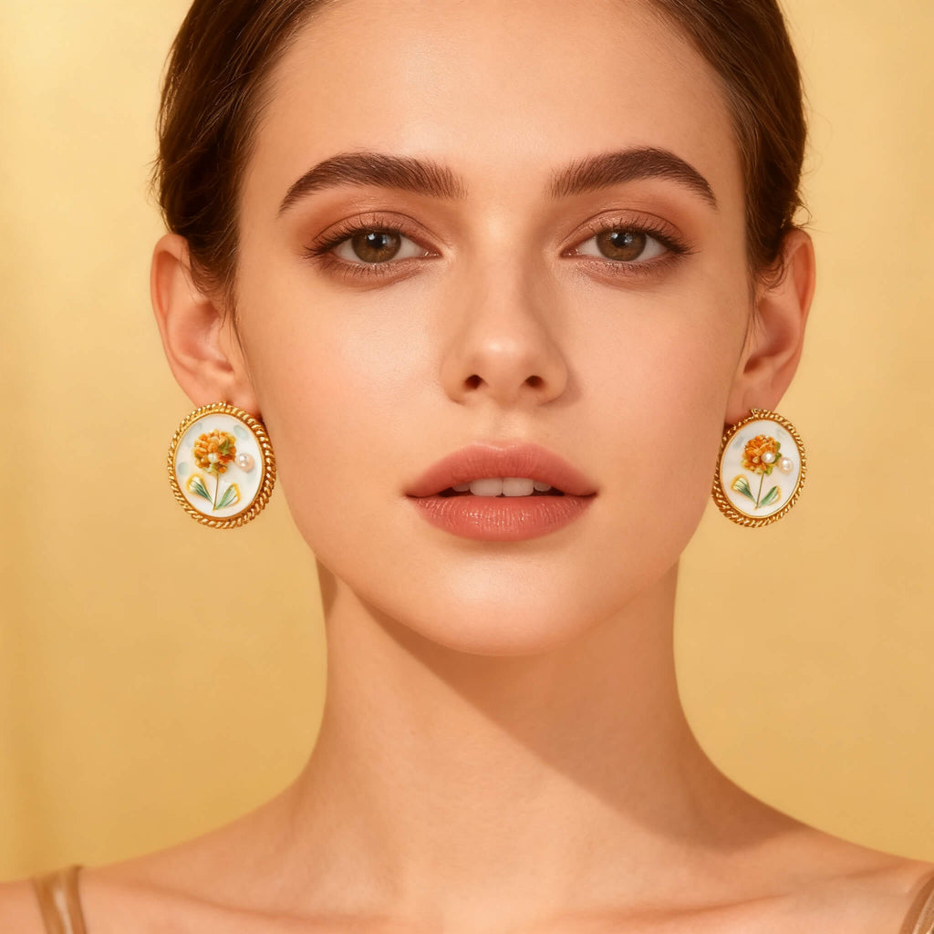 Elegant gold earrings decorated with hydrangea blooms in enamel.