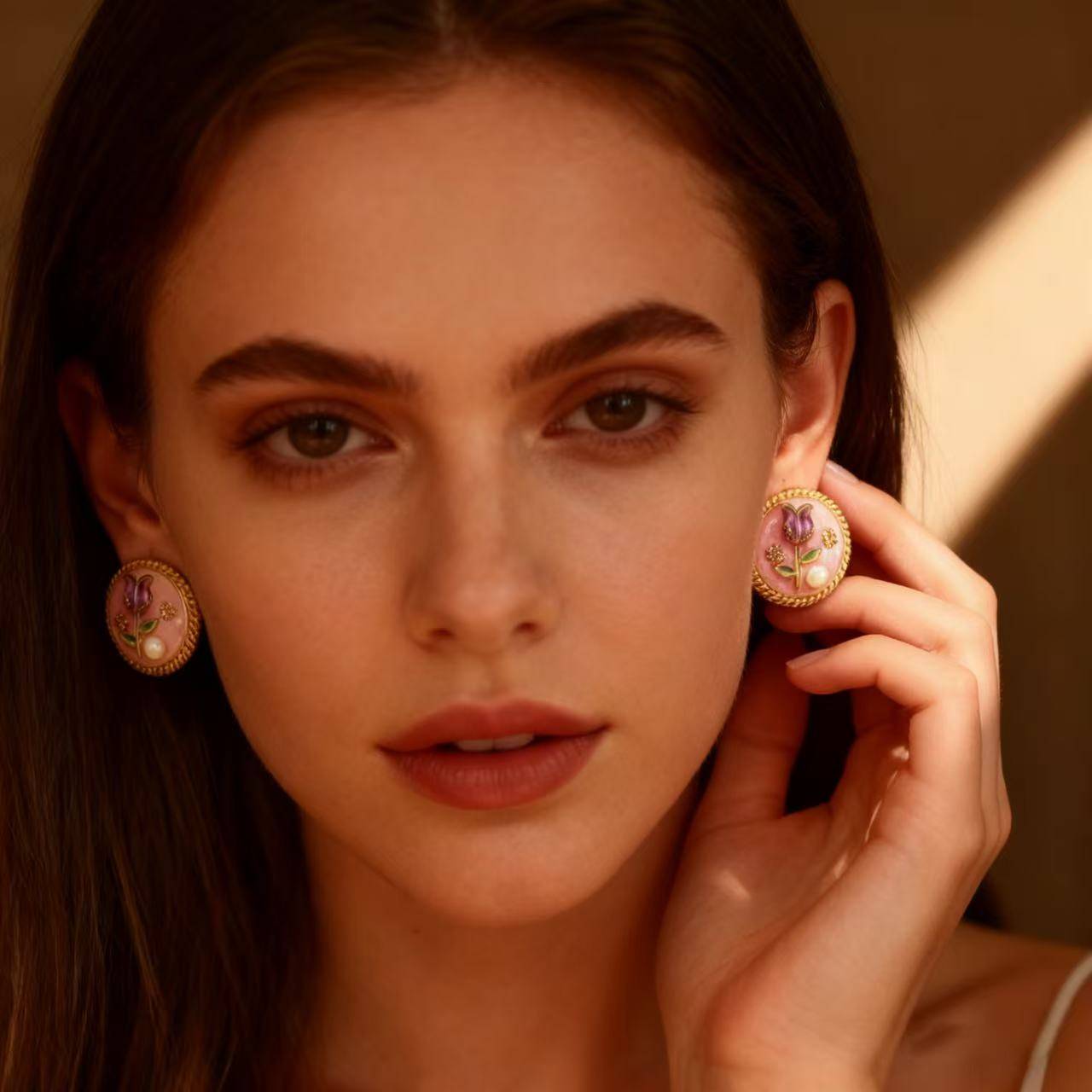 Feminine floral stud earrings inspired by vintage design, with soft pink enamel and gold edging.