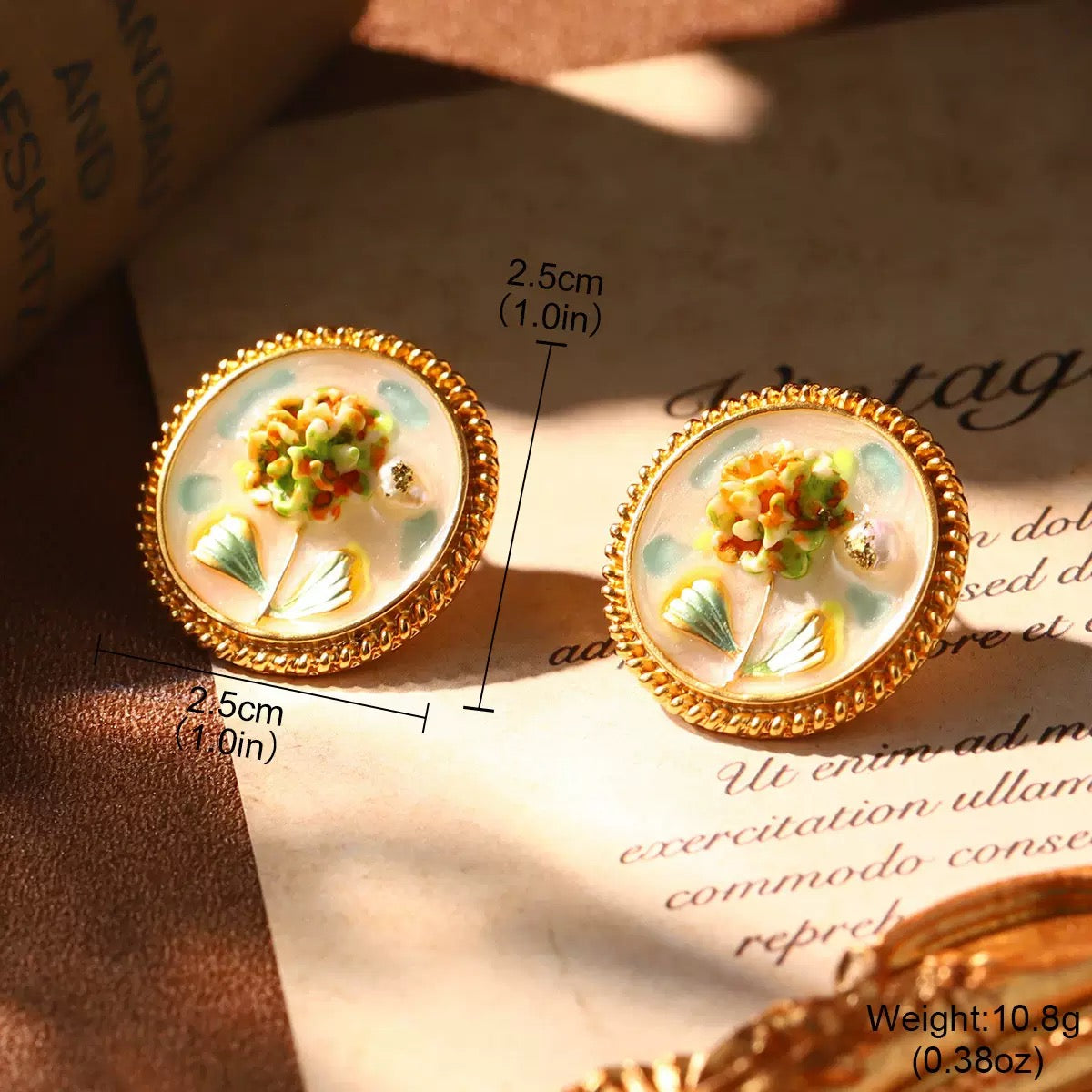 Vintage-style hydrangea flower earrings featuring gold trim and enamel art.