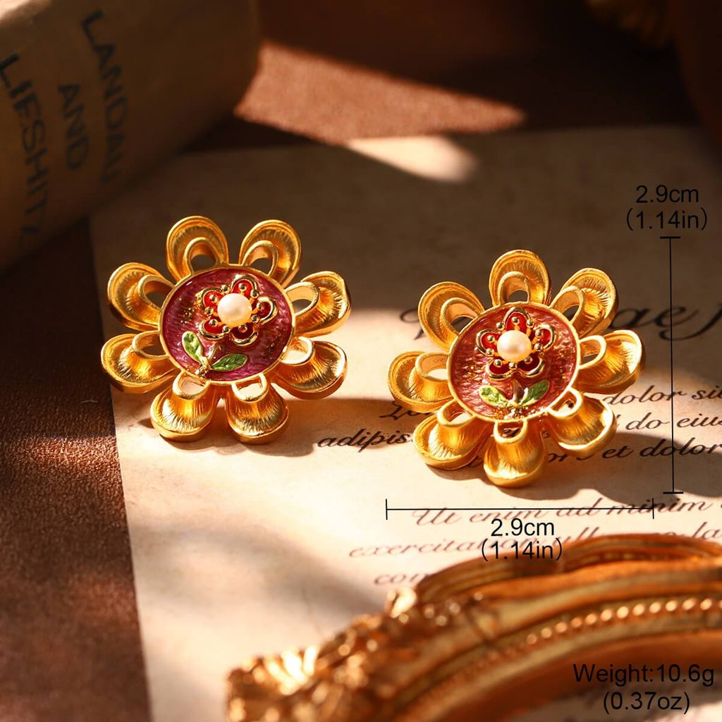 Elegant golden flower stud earrings featuring red enamel and a pearl accent, ideal for Christmas gifting.