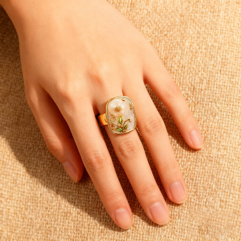 Elegant gold floral ring showcasing a pearl flower with detailed craftsmanship.
